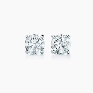 Tiffany solitaire diamond earrings in platinum .27 carat